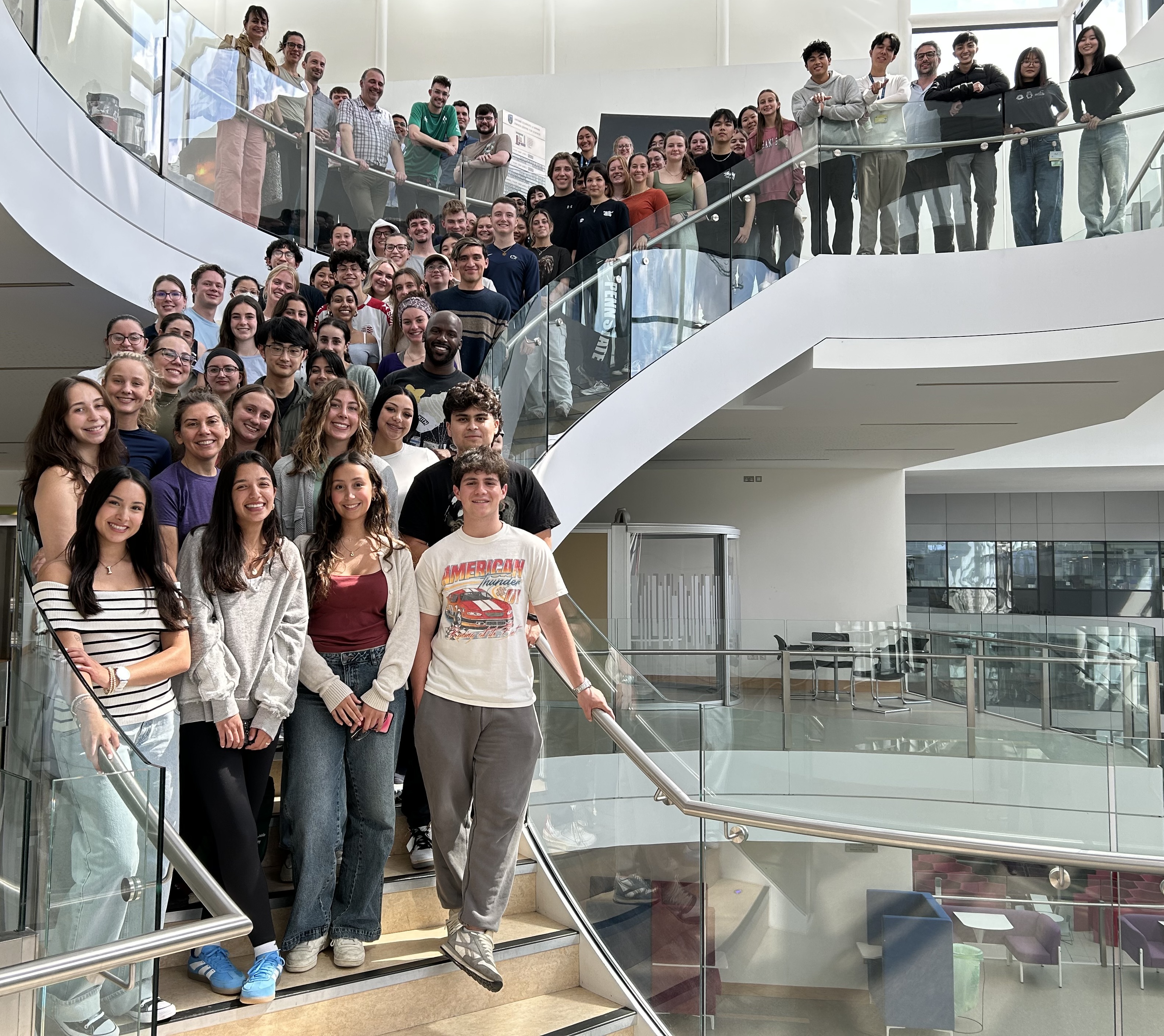 Group of students gathered on a glass staircase